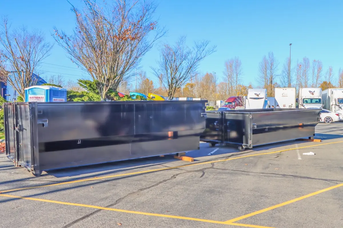 Professional dumpster rental service with roll-off container on residential driveway in Charlotte